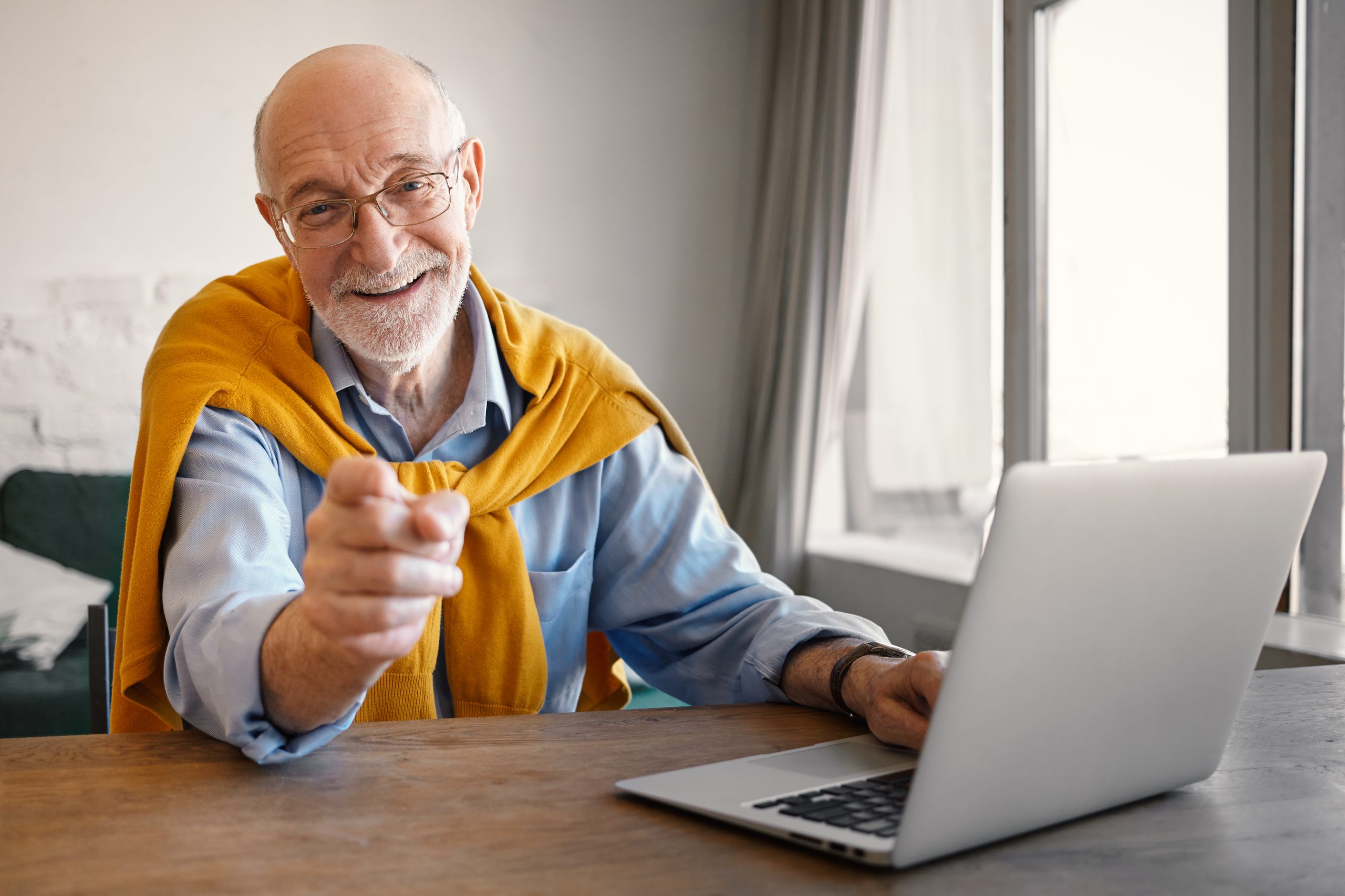 fashionable friendly elderly male recruiter wearing rectangular